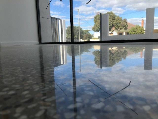 Full-height glazing over polished slab, Grange